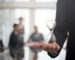 Businessman holding an hour glass, signifies the importance of being on time